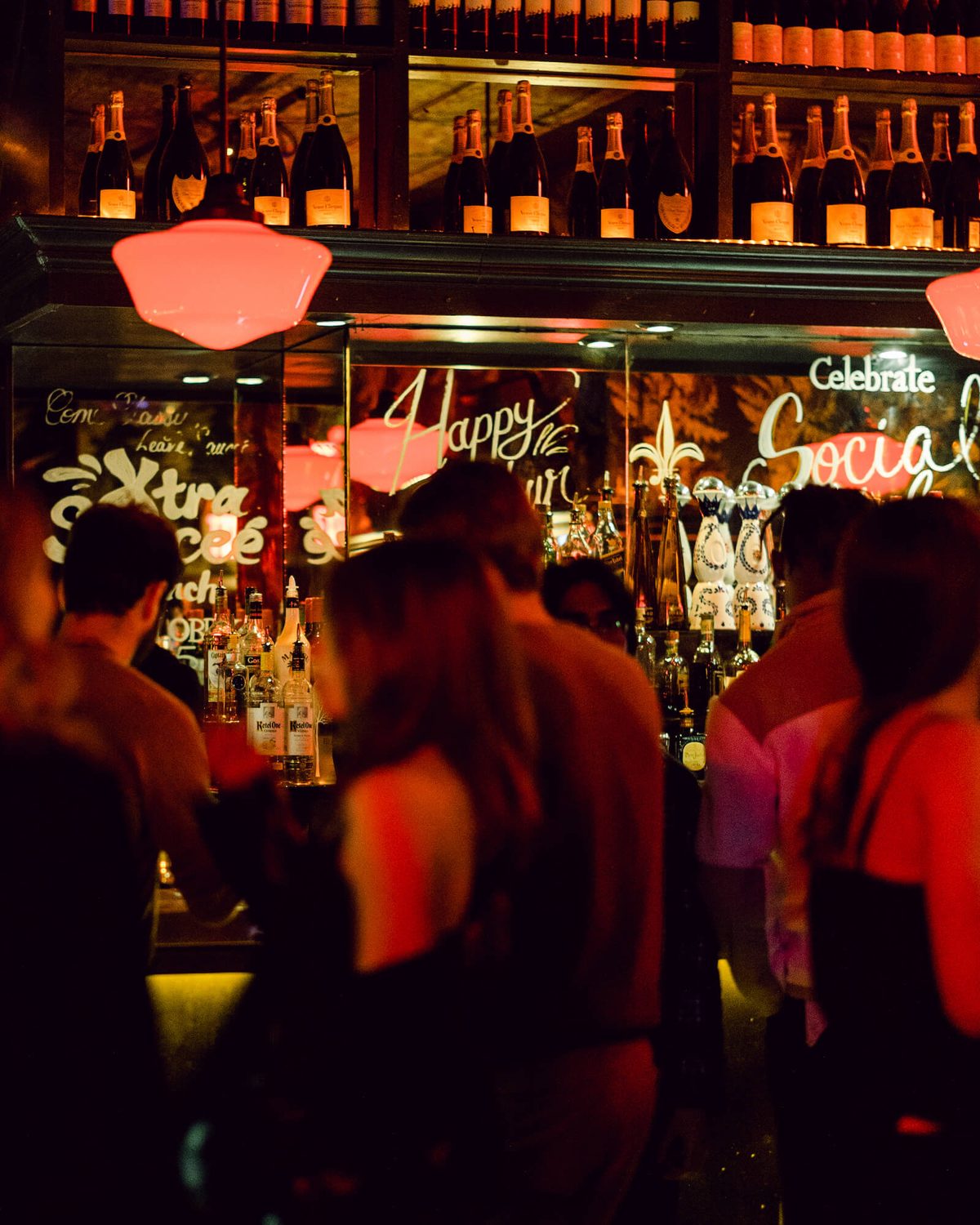 Crowd at the lobby bar in warm red light